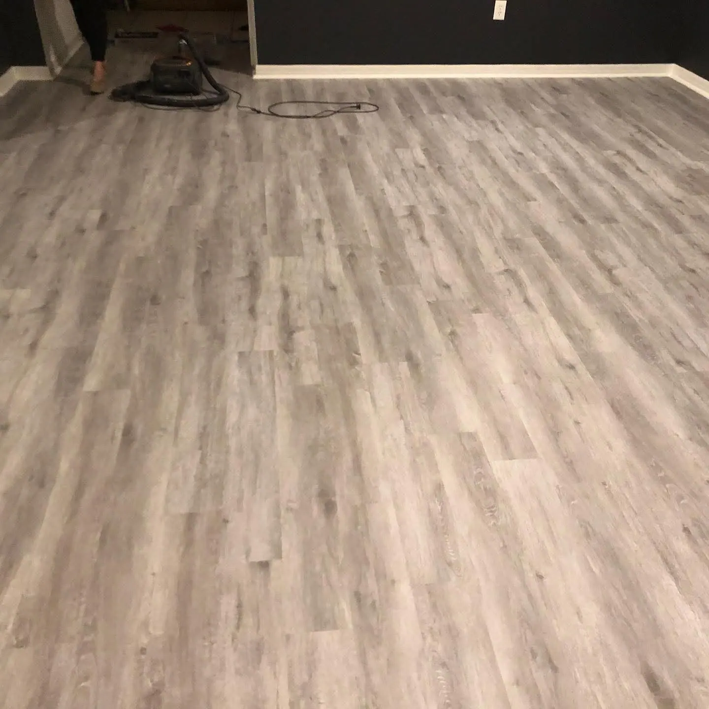 Completed light laminate flooring project by PalmPro